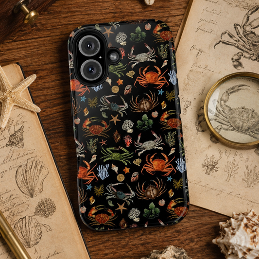 Phone case with sea crabs pattern on a wooden surface with vintage books and magnifying glass.