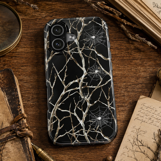 Phone case with spider web design on a wooden surface with books and magnifying glass