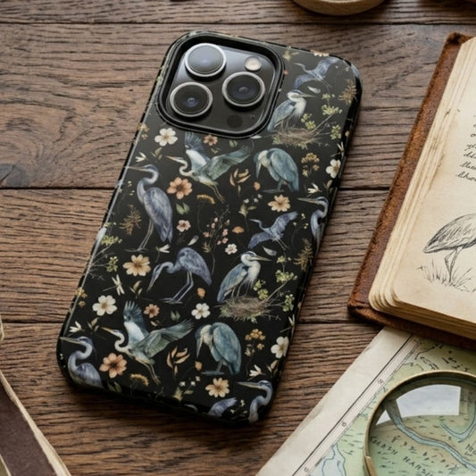 Phone case with nature design on a wooden table with books and magnifying glass
