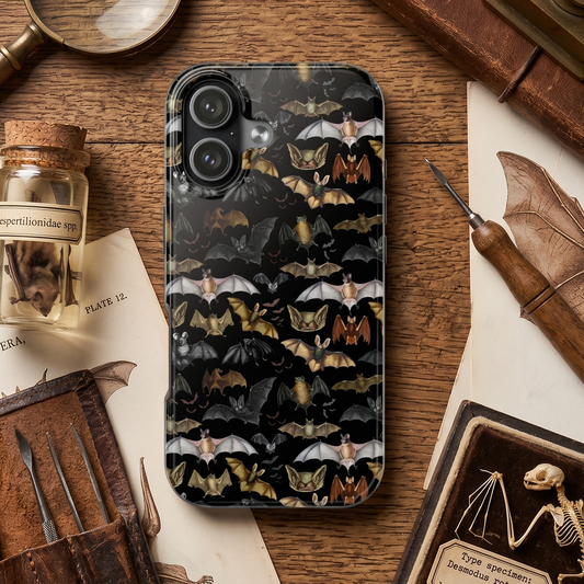 Phone case with bat design on a wooden surface with vintage items