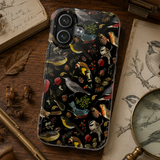 Phone case with nature-themed design on a wooden surface with books and magnifying glass.