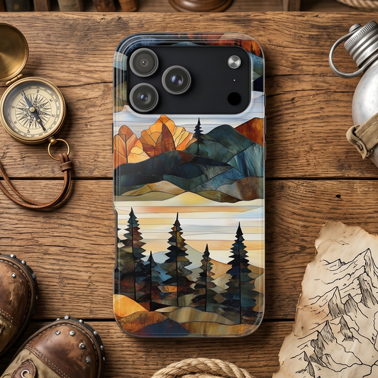 Phone case with mountain design on a wooden surface with travel-themed items