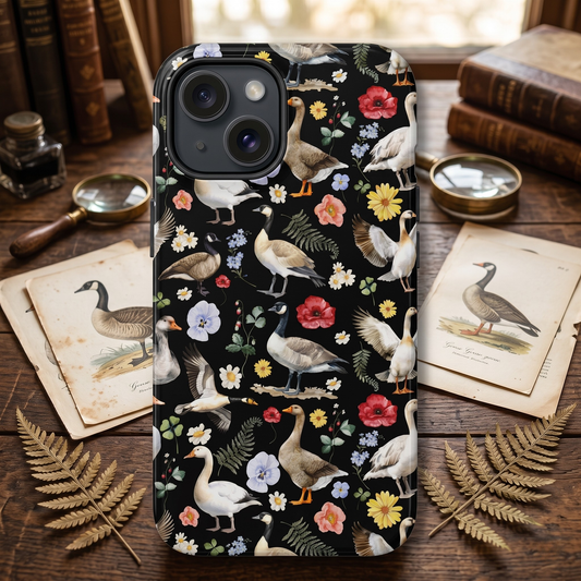 Phone case with bird and floral pattern on a wooden surface with books and leaves.